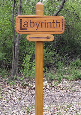 A photograph of a sign pointing the way to the Labyrinth